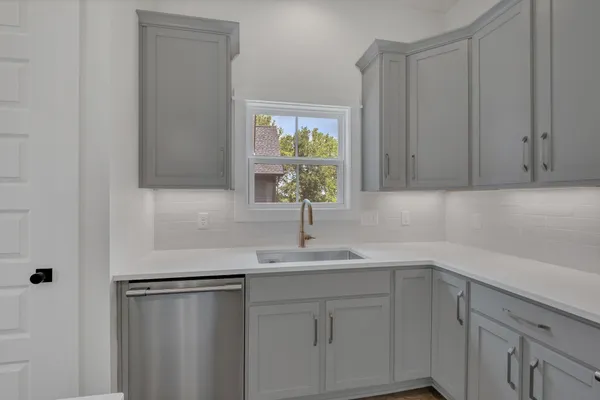 a kitchen with a sink and cabinets