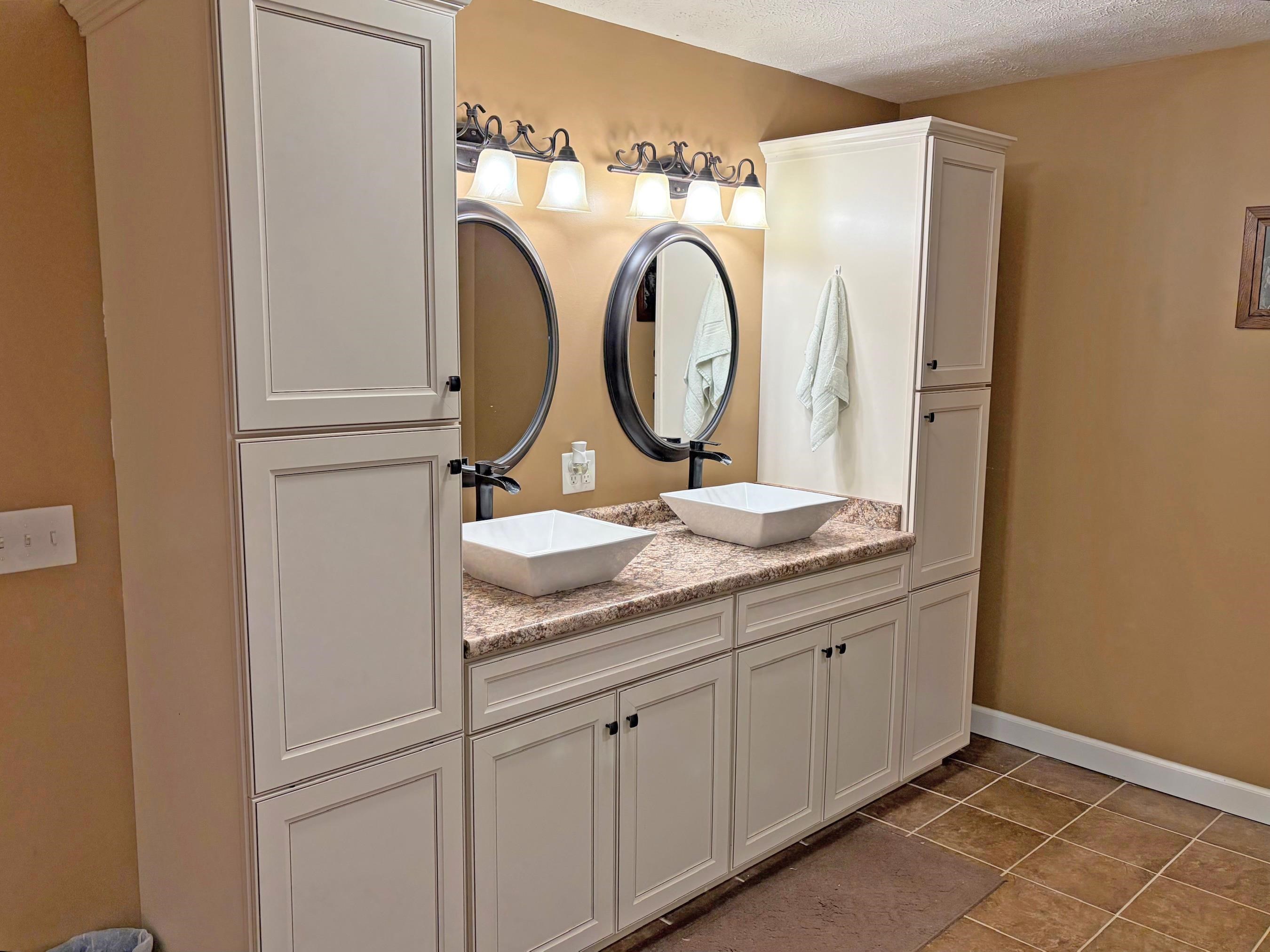 1255 Elm Road Adamsville, TN 38310 - Photo 15 of 32 a bathroom with a granite countertop sink and a mirror