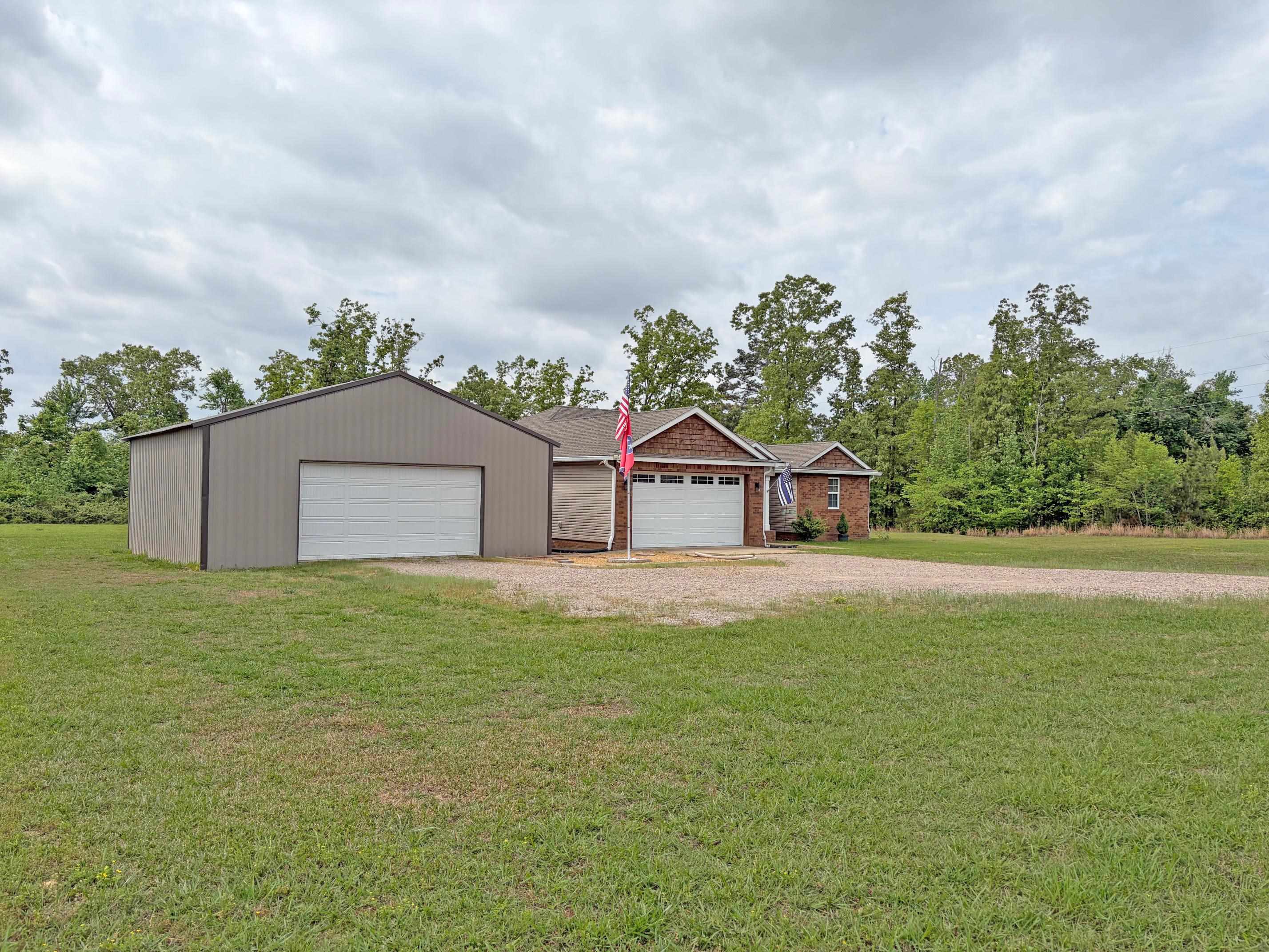 1255 Elm Road Adamsville, TN 38310 - Photo 22 of 32 a house with trees in the background