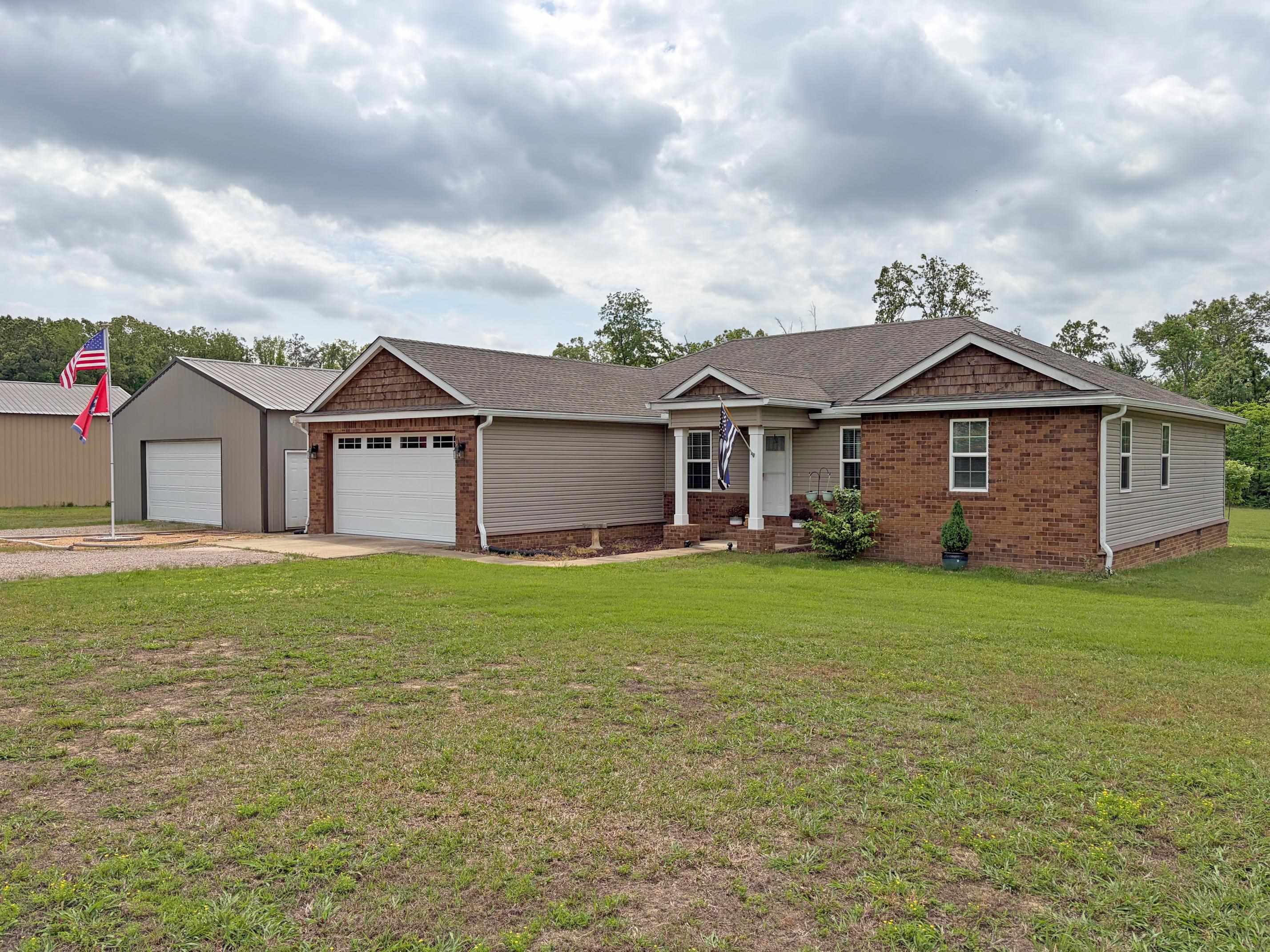 1255 Elm Road Adamsville, TN 38310 - Photo 23 of 32 a front view of a house with garden
