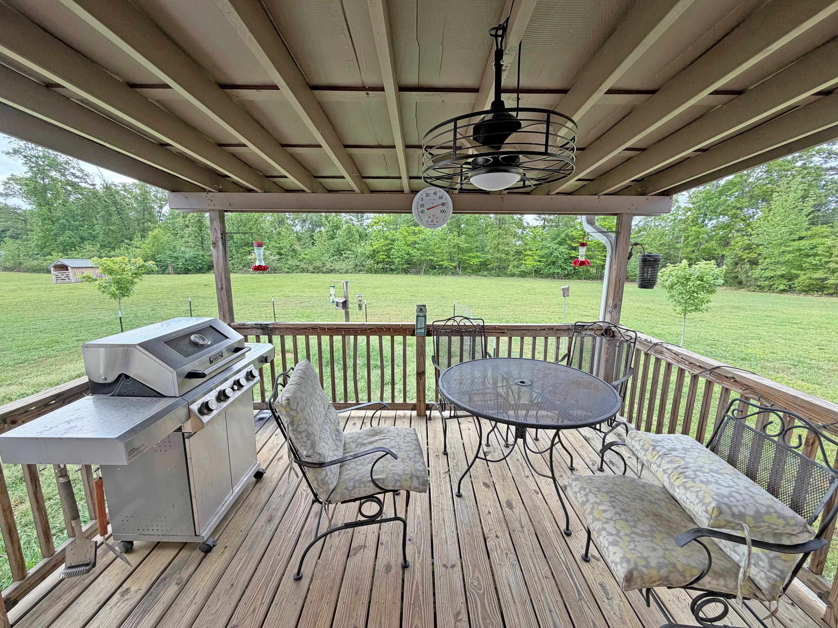 1255 Elm Road Adamsville, TN 38310 - Photo 30 of 32 a view of a chairs and table on the deck