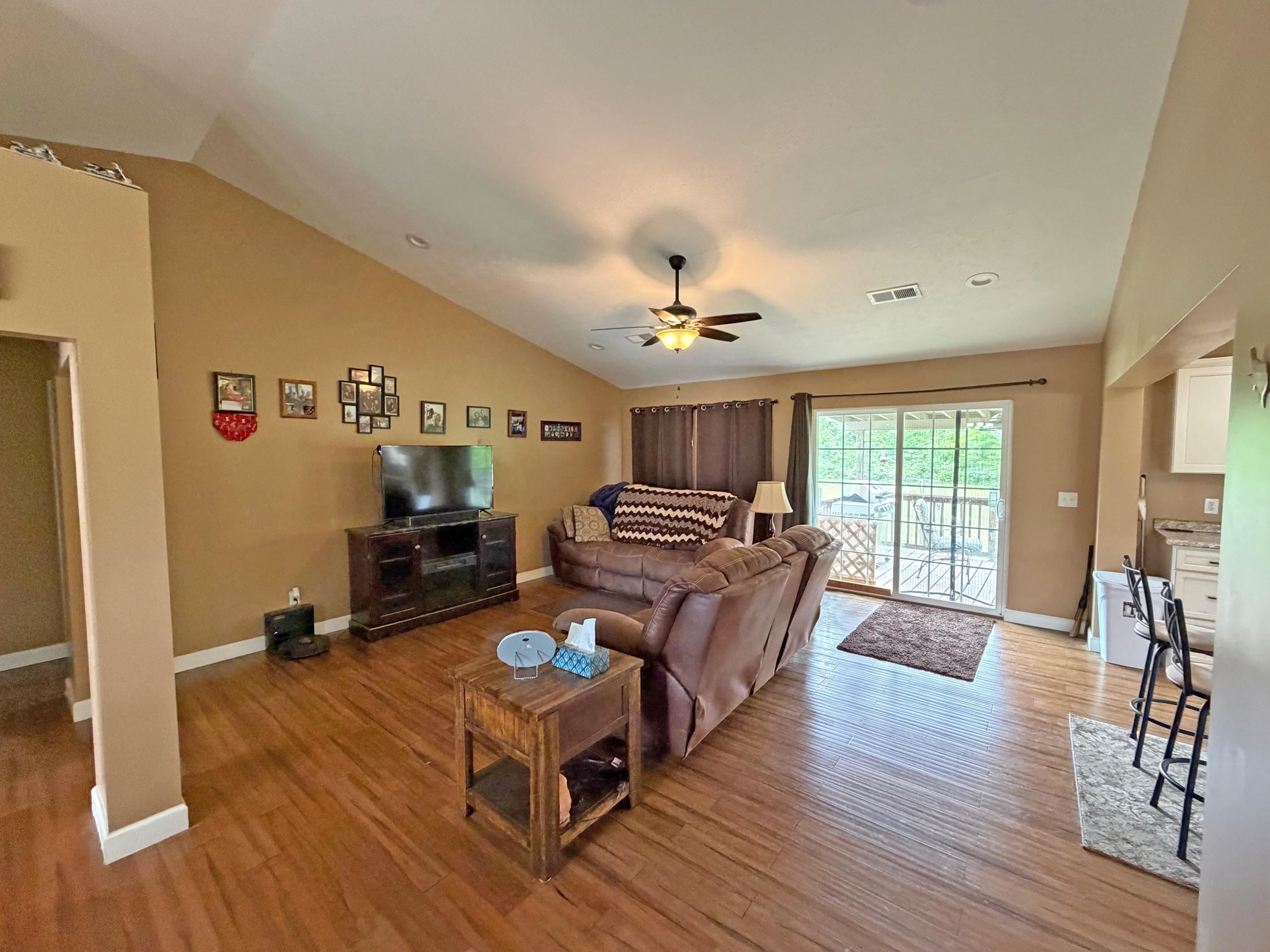 1255 Elm Road Adamsville, TN 38310 - Photo 7 of 32 a living room with furniture and a wooden floor