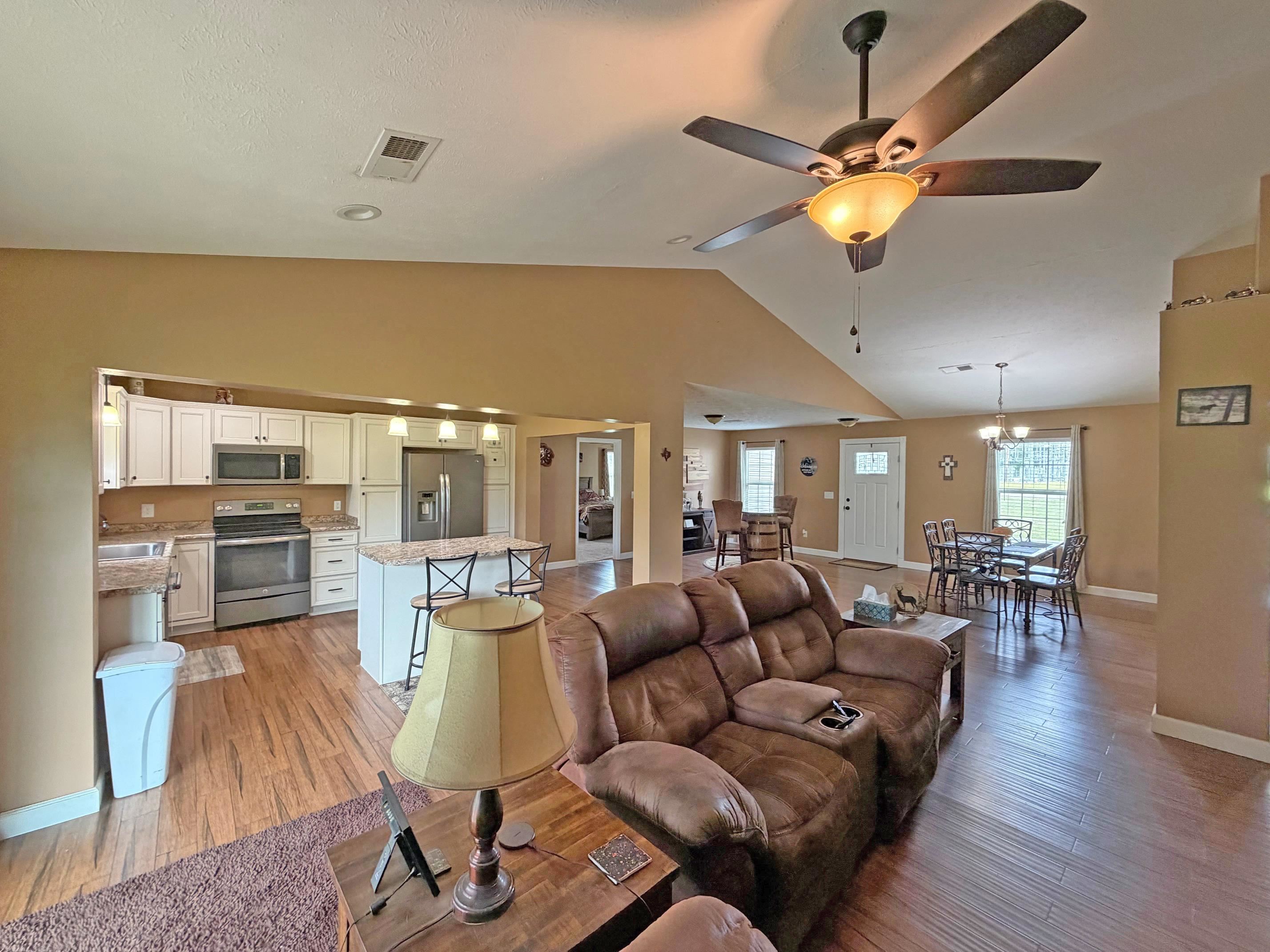 1255 Elm Road Adamsville, TN 38310 - Photo 9 of 32 a living room with furniture and a chandelier