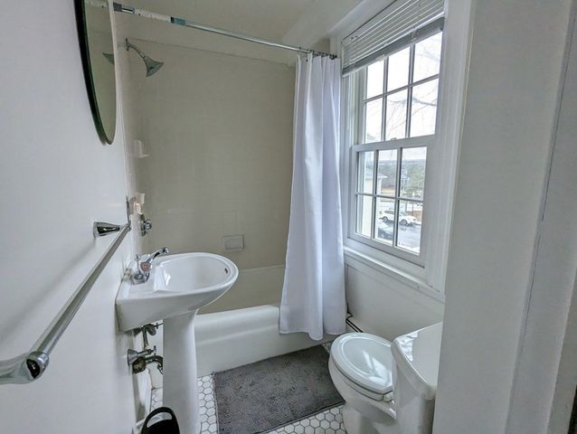a bathroom with a sink toilet and a mirror