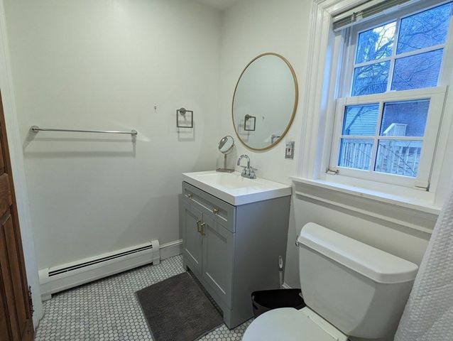 a bathroom with a toilet a sink and a mirror