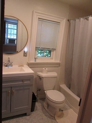 a bathroom with a sink toilet and a mirror
