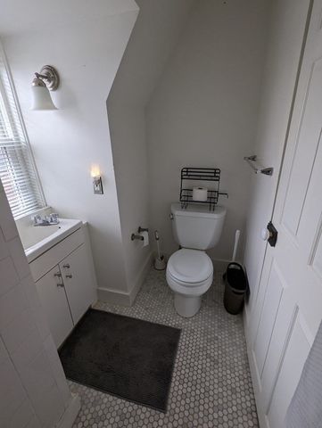 a bathroom with a toilet and a mirror