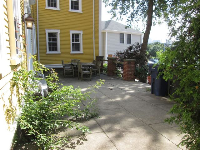 a backyard of a house with outdoor seating