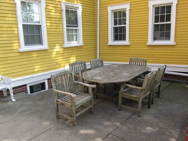 a view of a dinning table and chairs in patio of the house