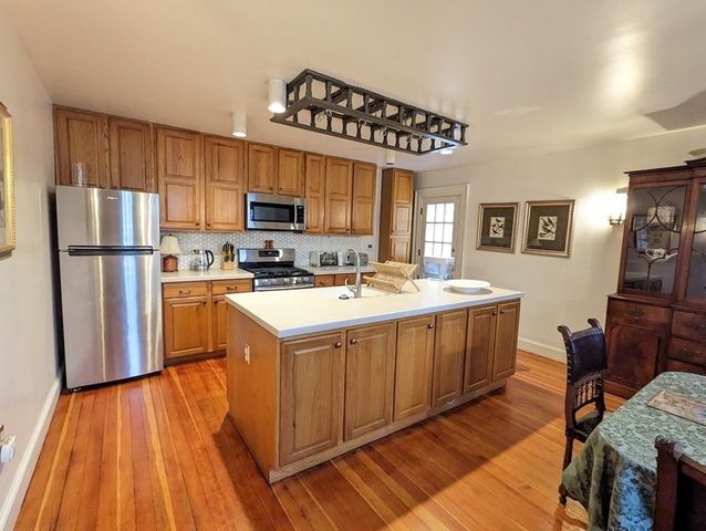 a kitchen with a sink appliances and cabinets