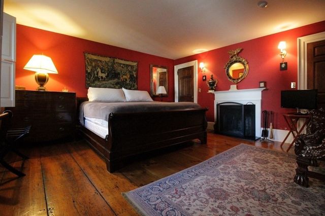 a bed room with a bed and a fireplace