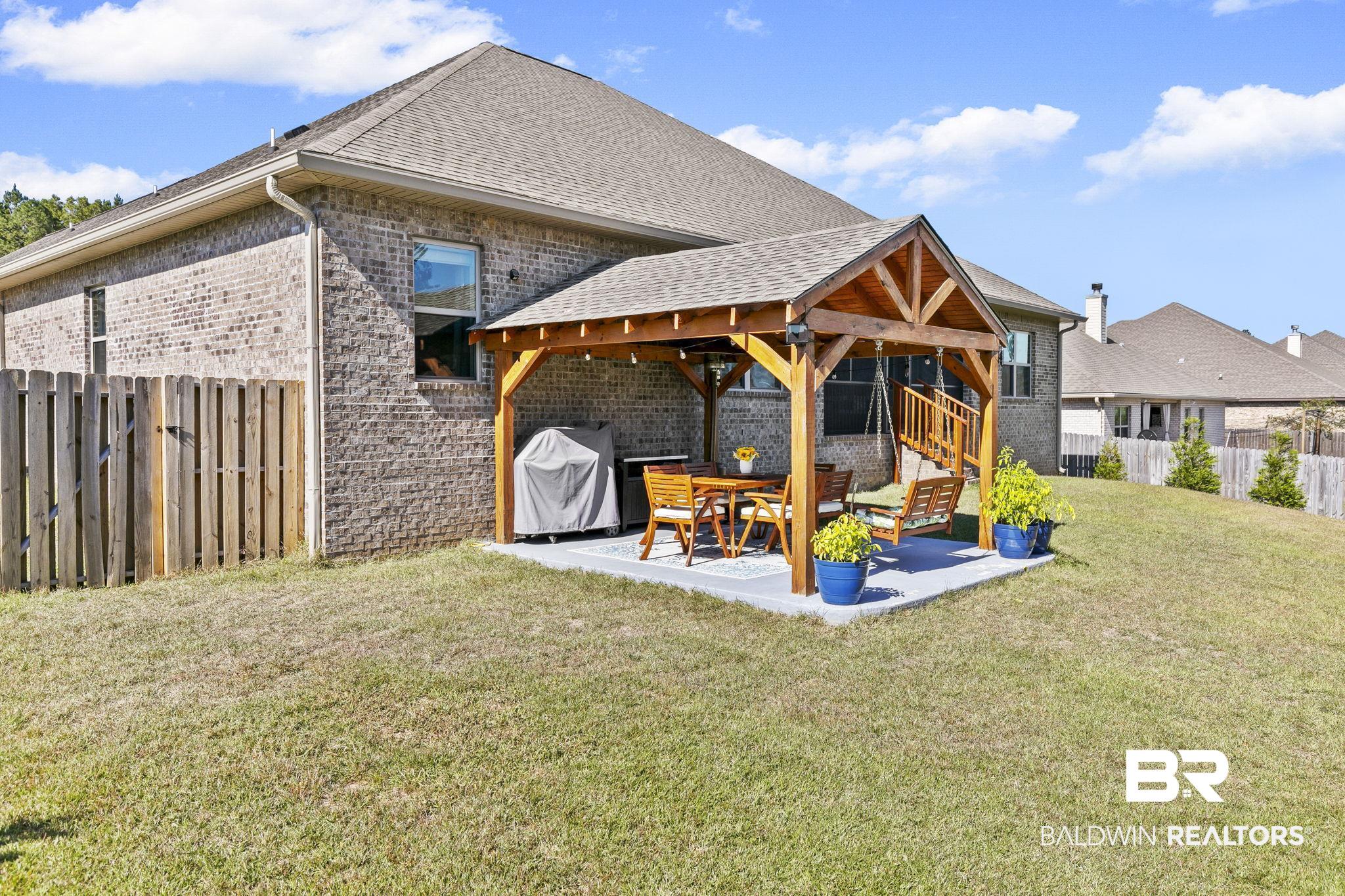 31500 Spoonbill Road Daphne, AL 36527 - Photo 52 of 85 Rear view of house with a patio and a yard