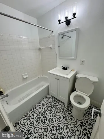 a bathroom with a sink toilet a mirror and shower