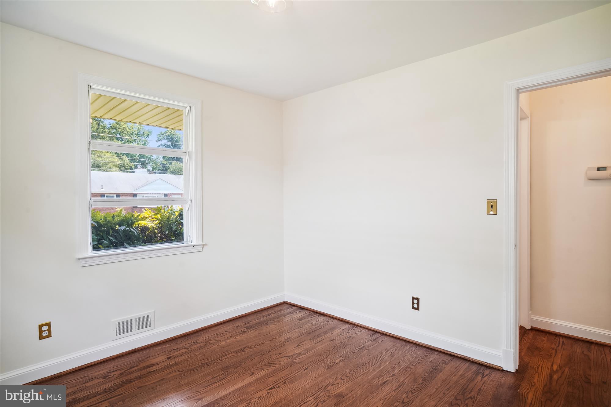 10106 Portland Place Silver Spring, MD 20901 - Photo 23 of 38 an empty room with wooden floor and windows