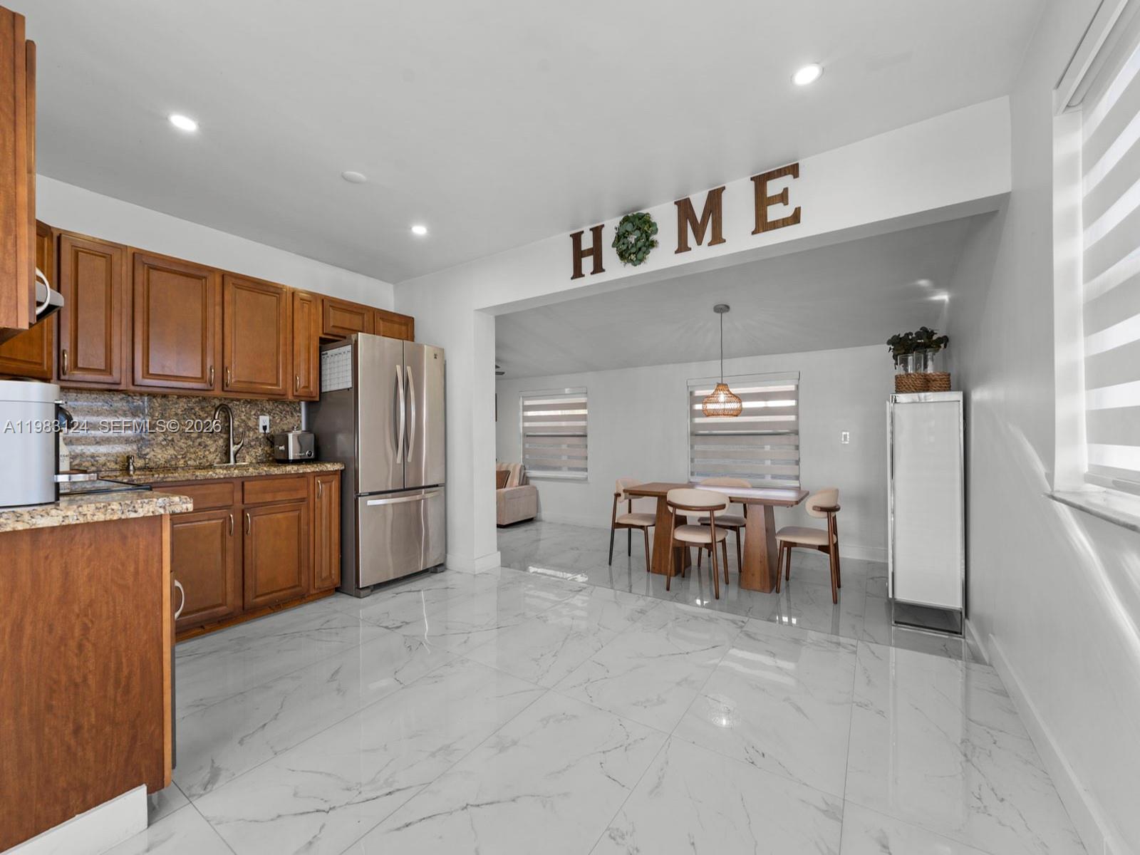 120 West 50th Street Hialeah, FL 33012 - Photo 11 of 37 a kitchen with refrigerator cabinets and chair