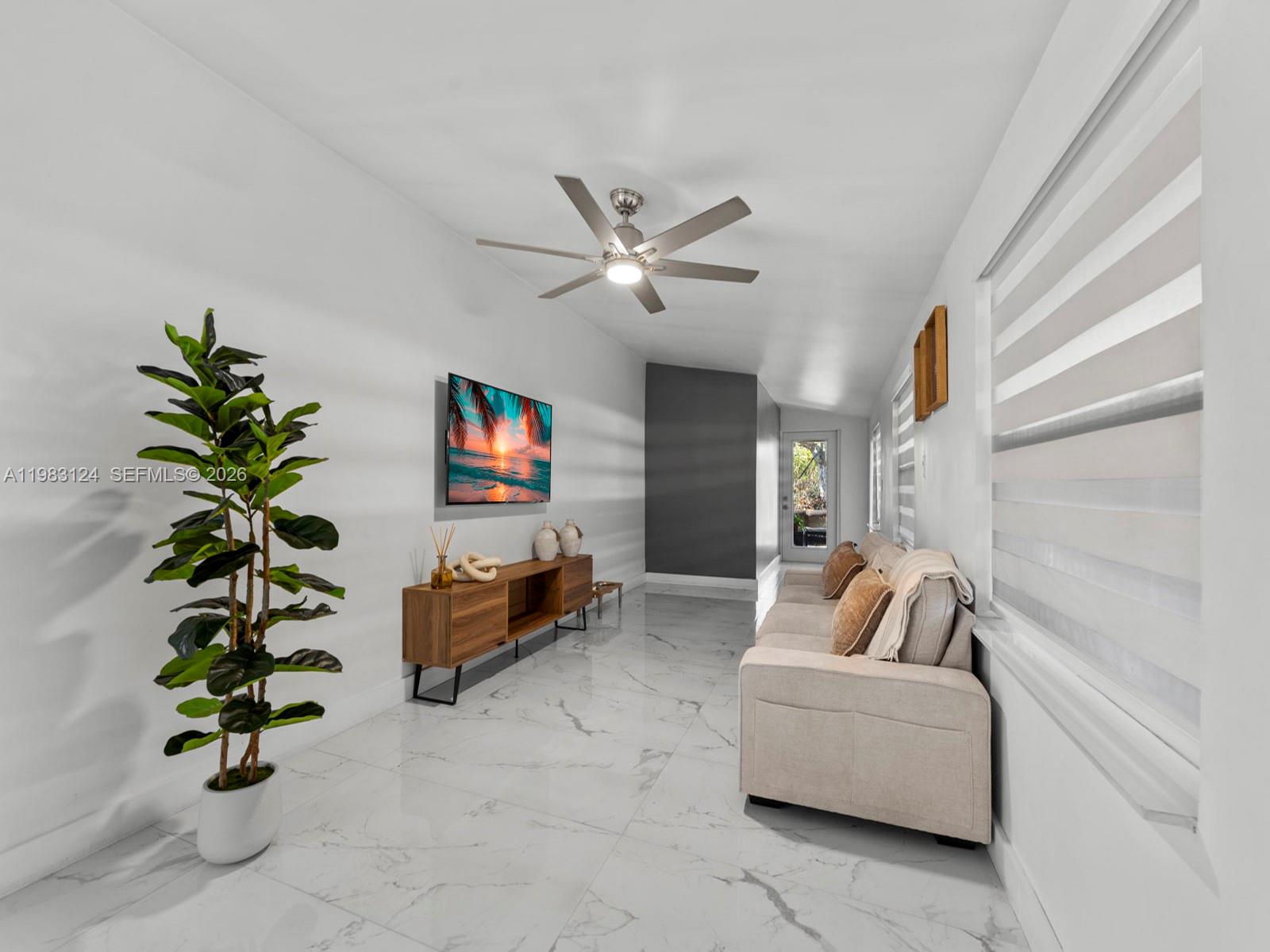 120 West 50th Street Hialeah, FL 33012 - Photo 15 of 37 a living room with furniture and a potted plant