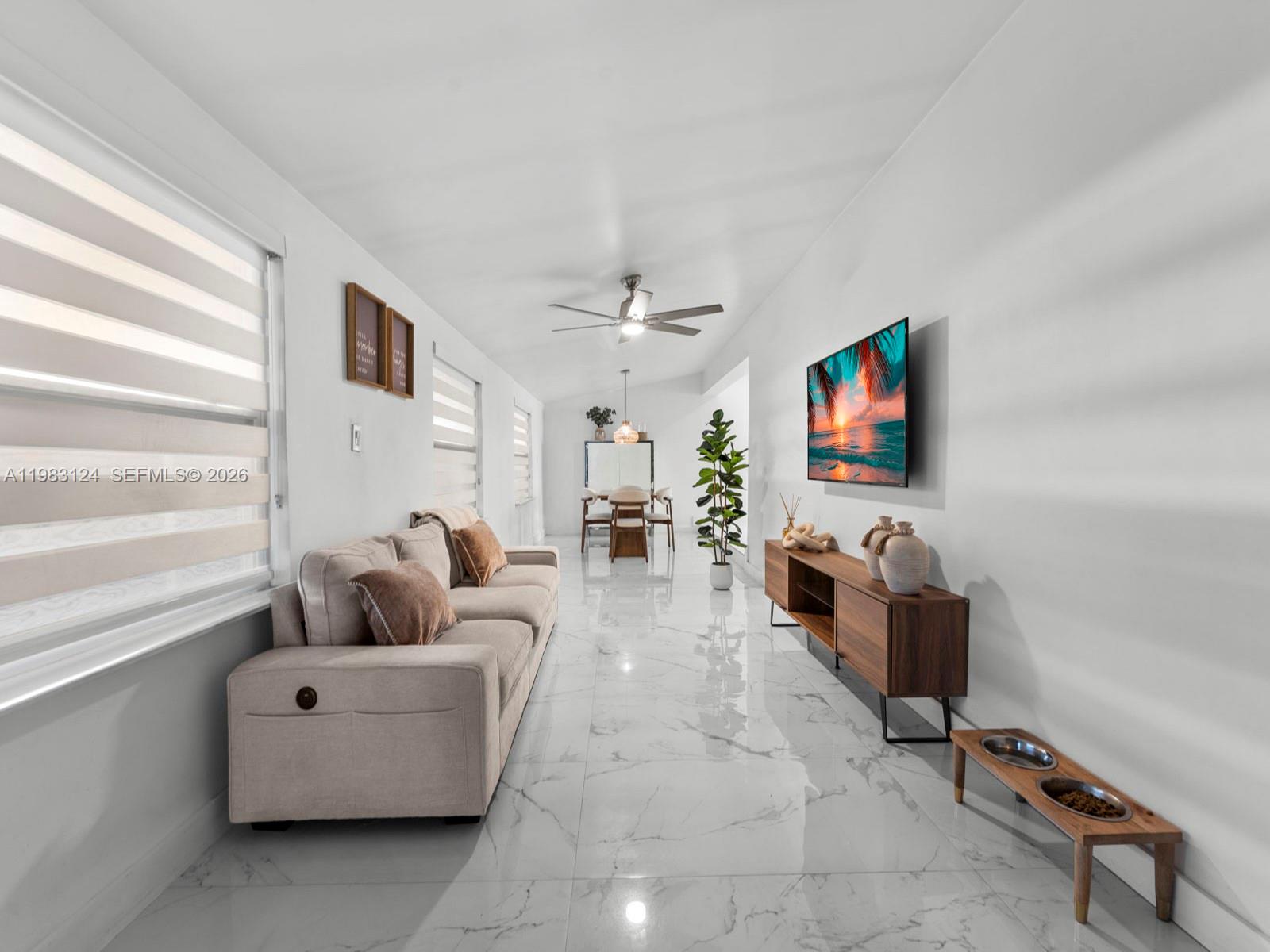 120 West 50th Street Hialeah, FL 33012 - Photo 16 of 37 a living room with furniture and a flat screen tv