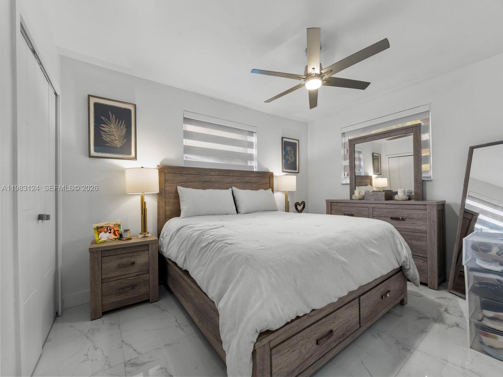 120 West 50th Street Hialeah, FL 33012 - Photo 25 of 37 a bedroom with a bed and a chandelier