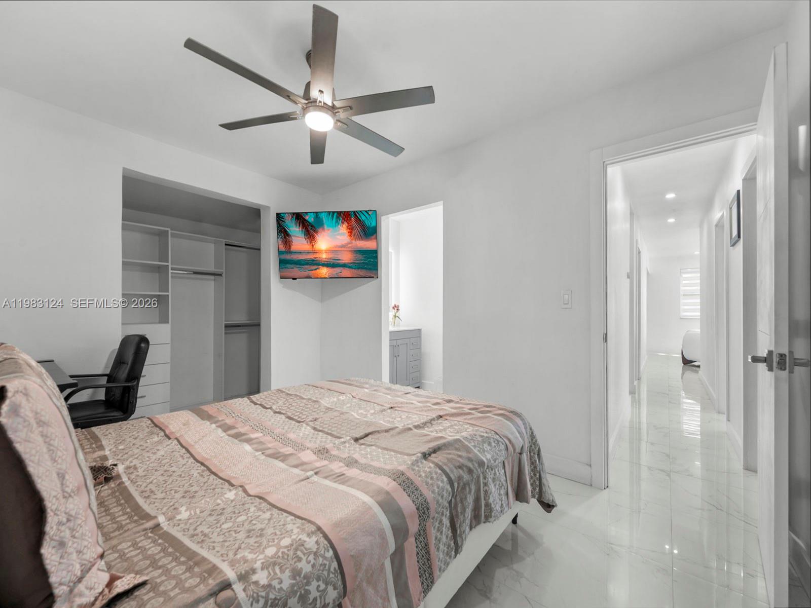 120 West 50th Street Hialeah, FL 33012 - Photo 29 of 37 a bedroom with a bed and a chandelier