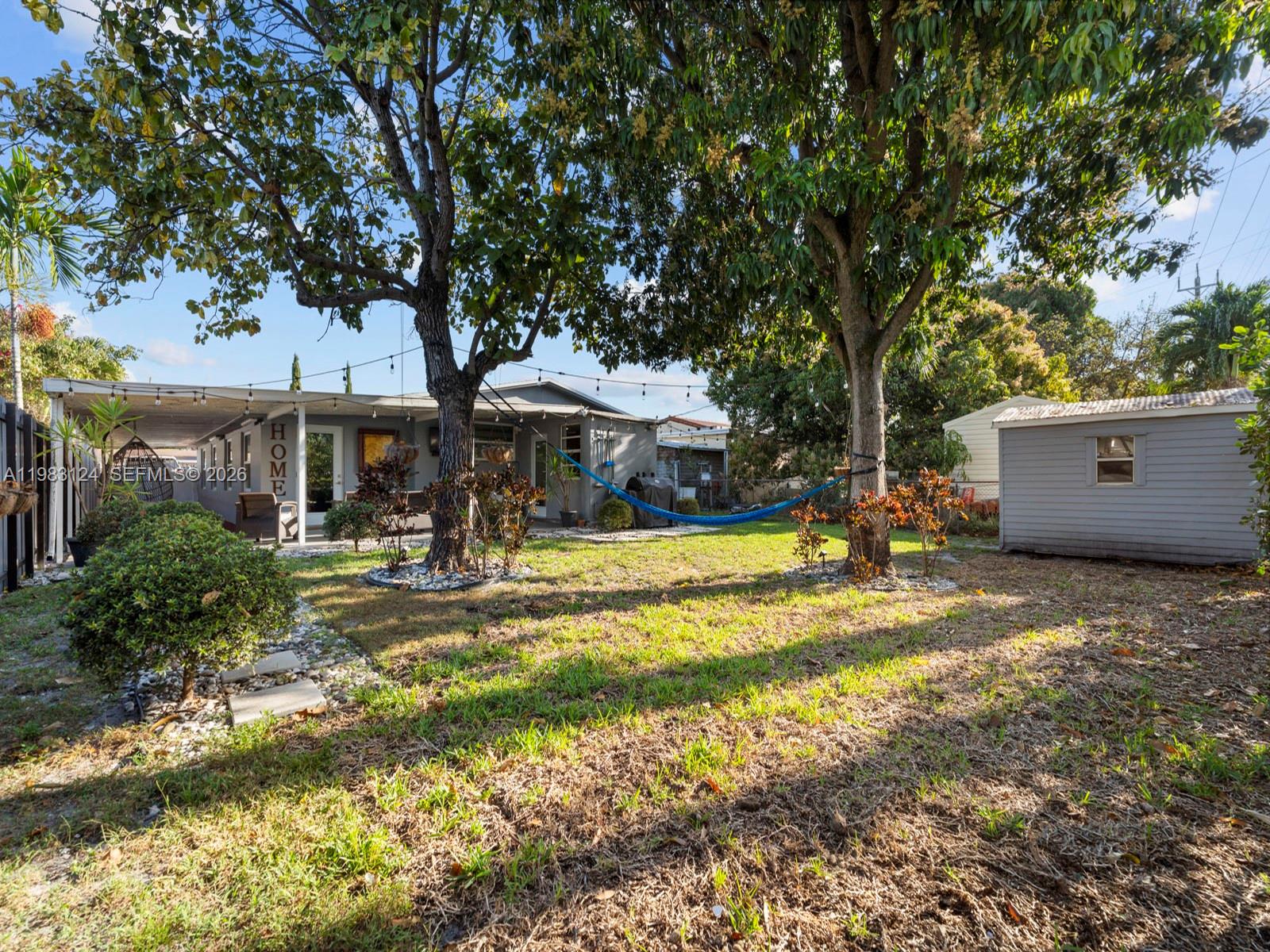 120 West 50th Street Hialeah, FL 33012 - Photo 34 of 37 a view of a house with swimming pool and sitting area