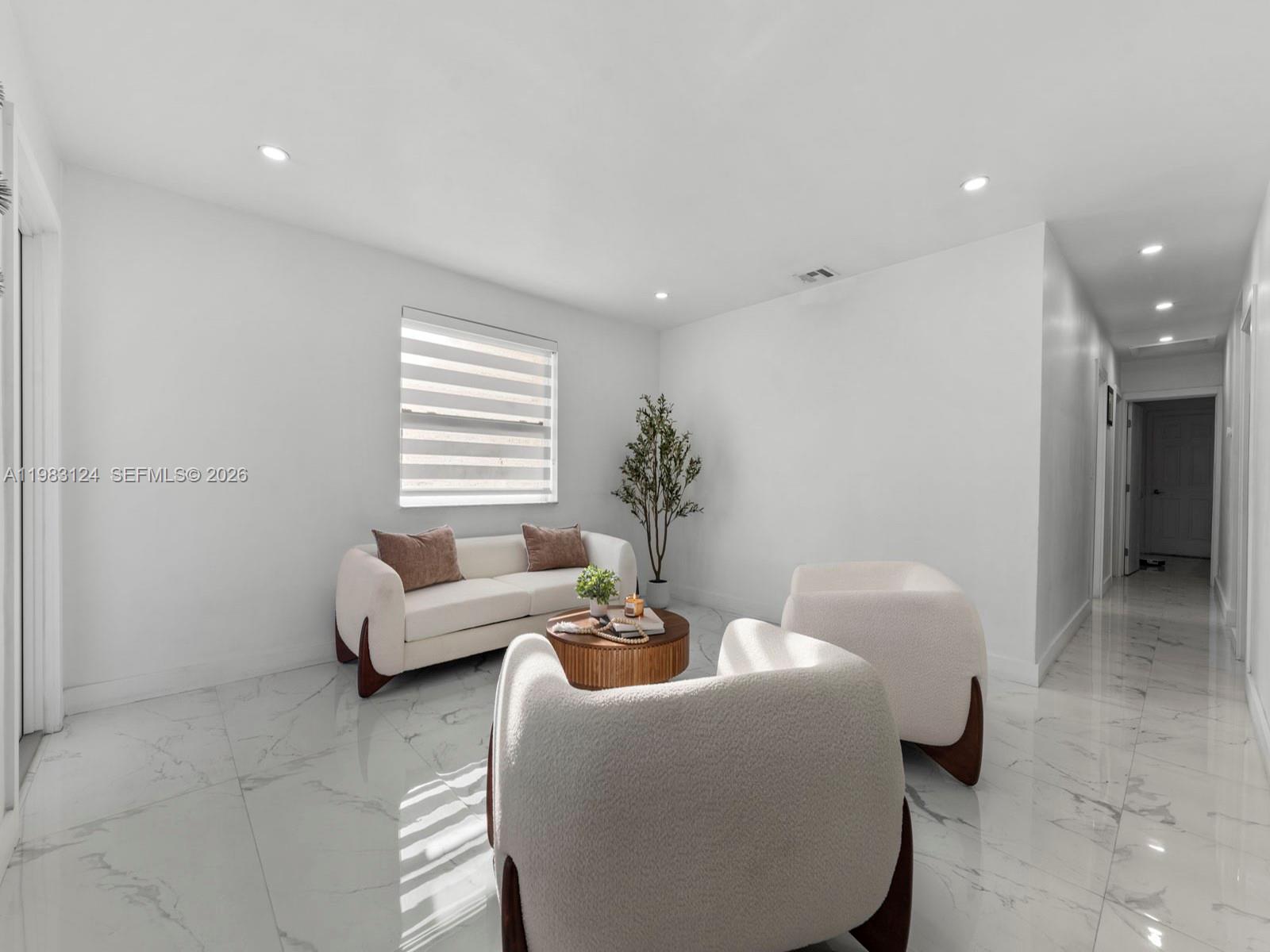 120 West 50th Street Hialeah, FL 33012 - Photo 10 of 37 a living room with furniture and a window