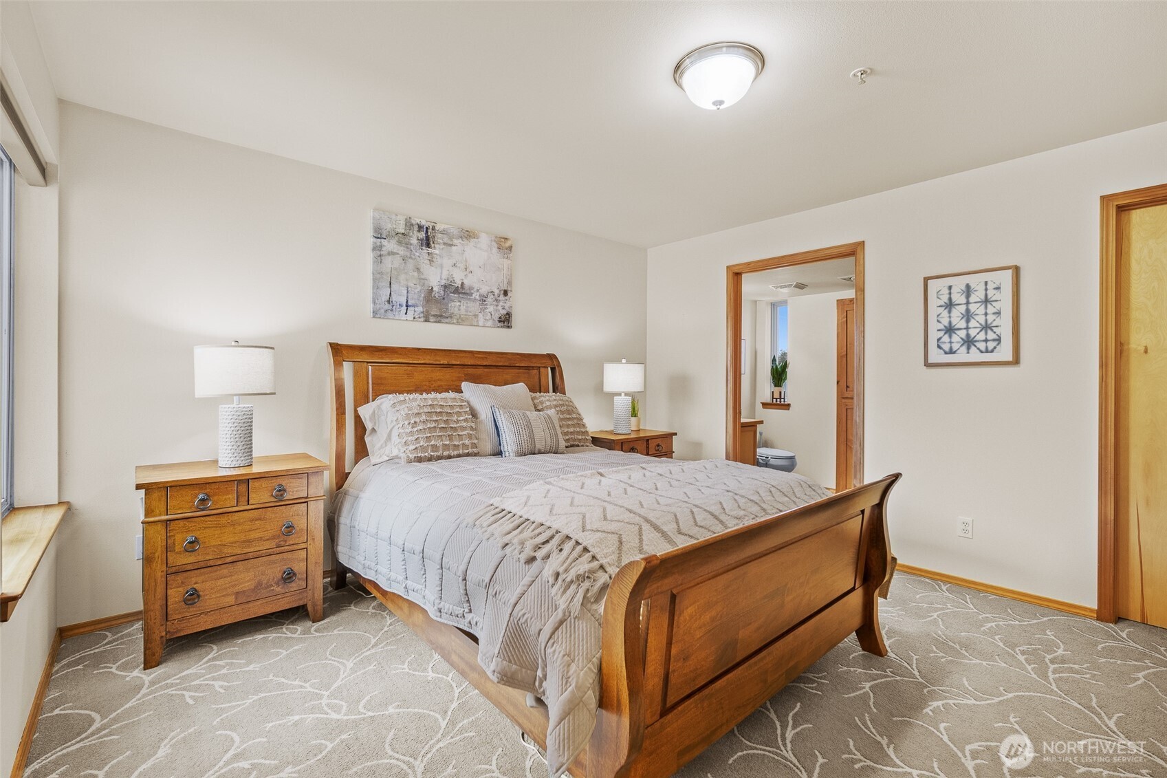 1011 Bancroft Street, Unit 204 Bellingham, WA 98225 - Photo 18 of 32 a bedroom with bed and paintings on the wall