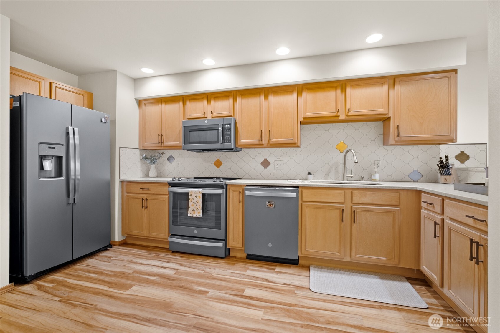 1011 Bancroft Street, Unit 204 Bellingham, WA 98225 - Photo 3 of 32 a kitchen with stainless steel appliances granite countertop a refrigerator and a stove top oven