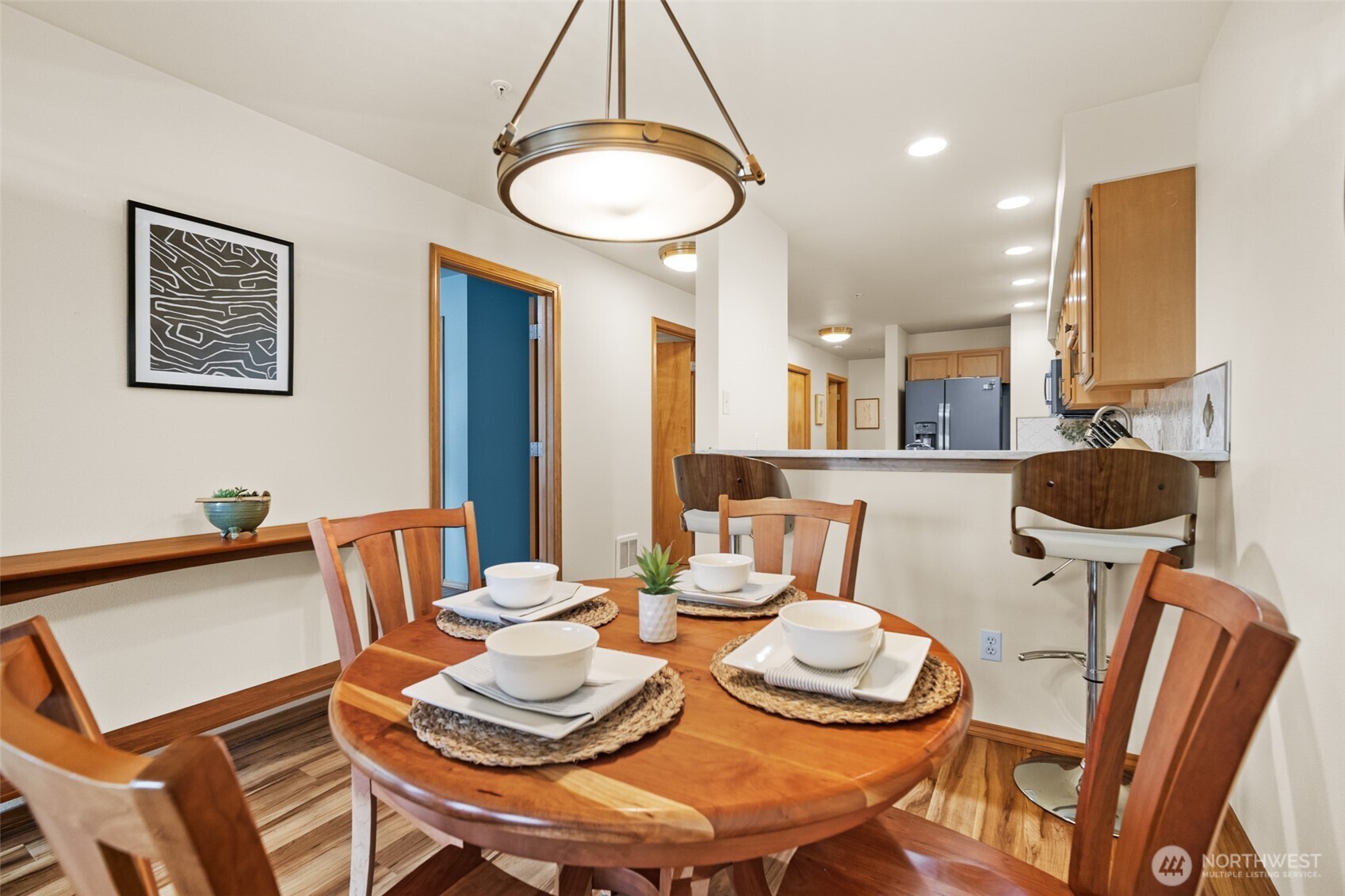 1011 Bancroft Street, Unit 204 Bellingham, WA 98225 - Photo 9 of 32 a dining room with furniture a table and kitchen chandelier