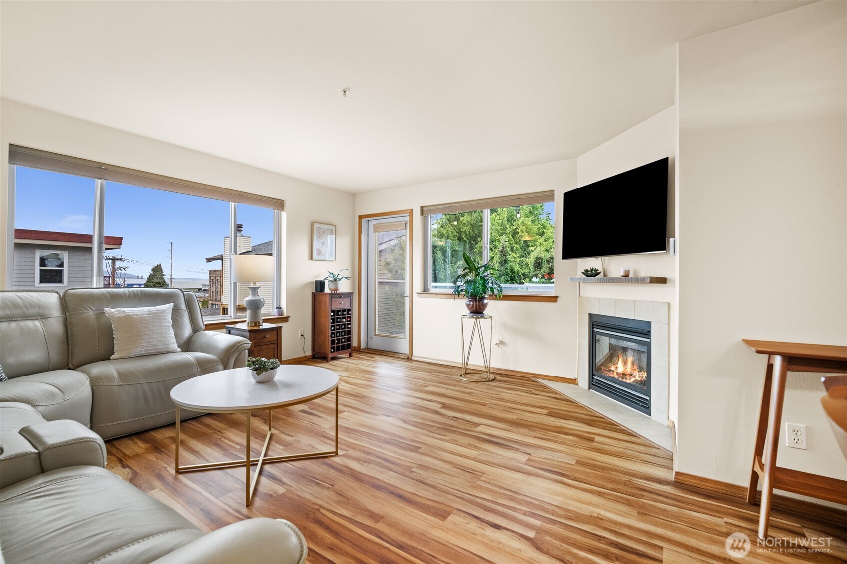 1011 Bancroft Street, Unit 204 Bellingham, WA 98225 - Photo 10 of 32 a living room with furniture a fireplace and a flat screen tv