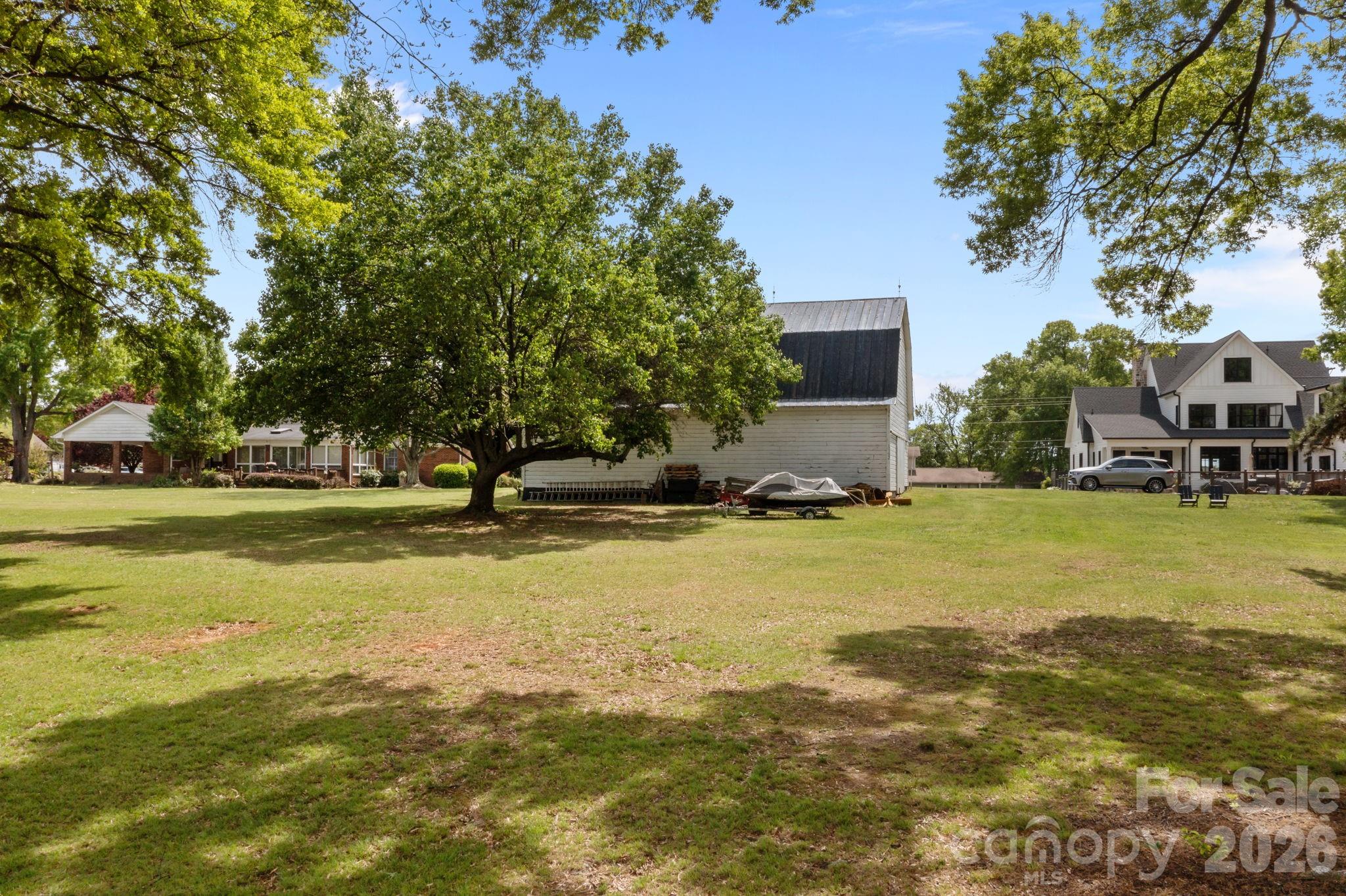 21422 Bethel Church Road Cornelius, NC 28031 - Photo 13 of 19 a view of swimming pool with outdoor seating and trees
