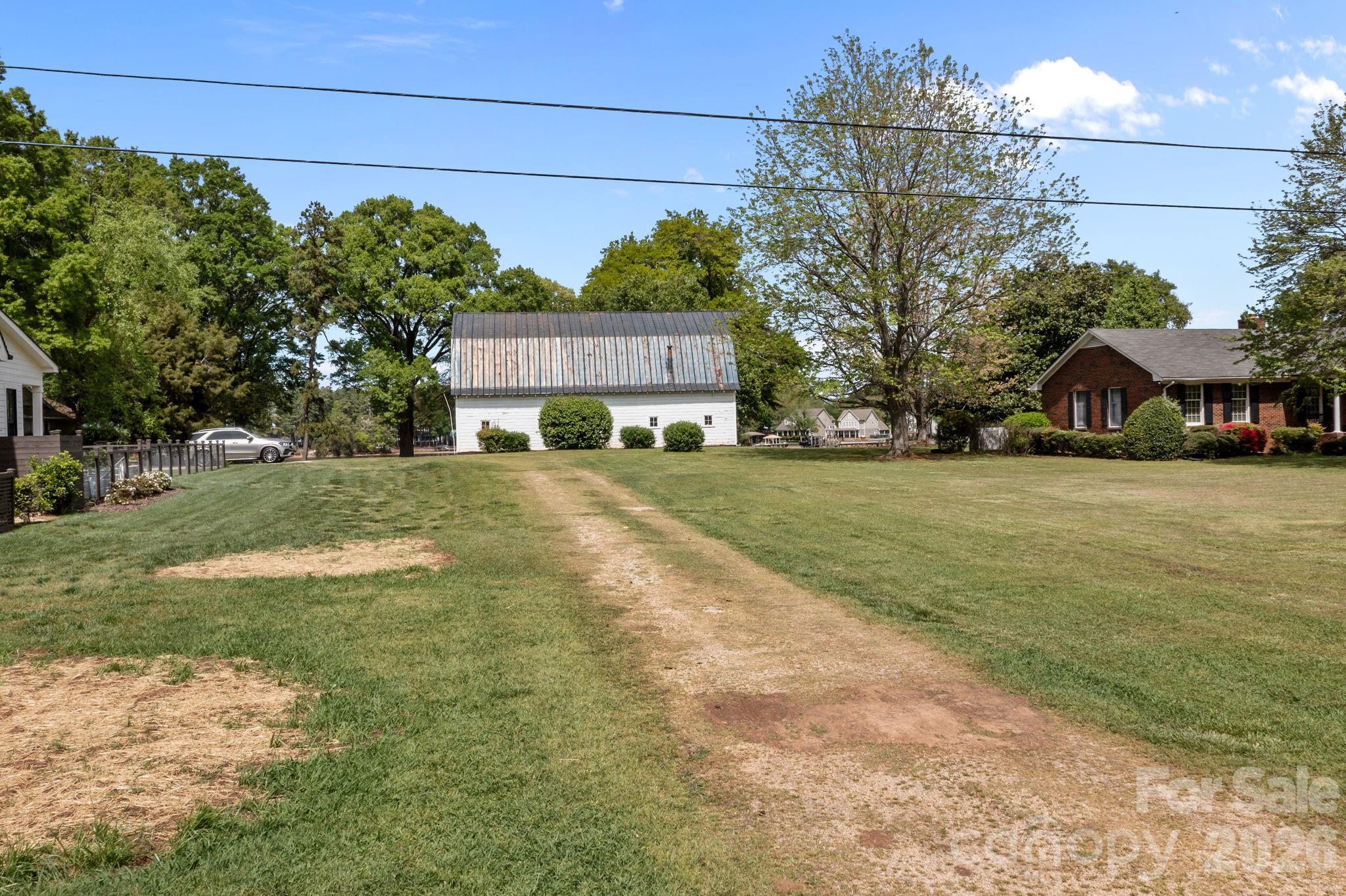 21422 Bethel Church Road Cornelius, NC 28031 - Photo 16 of 19 a view of a house with a yard and garage