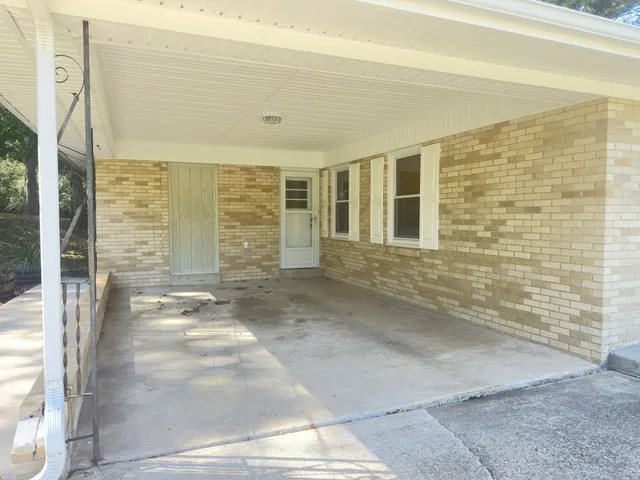 a view of a brick house with an outdoor space