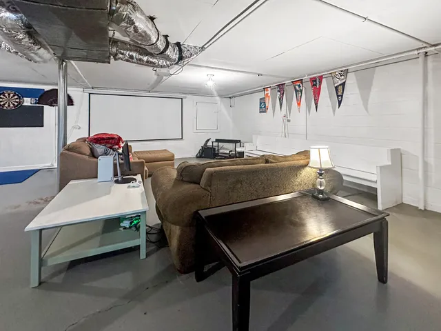 a living room with lots of furniture and a chandelier