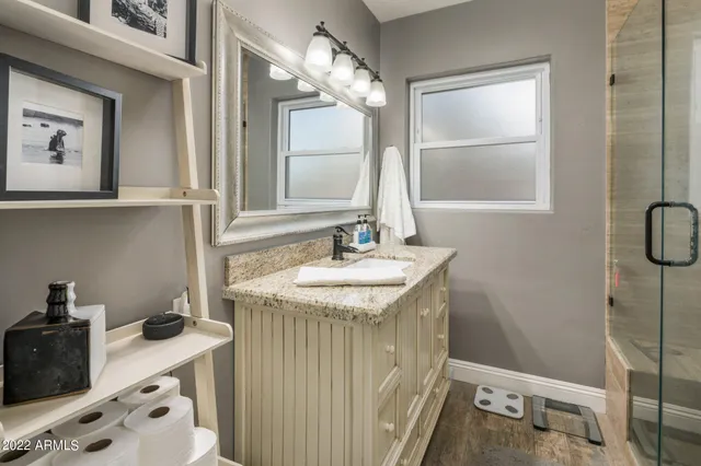 a bathroom with a sink a vanity and a mirror