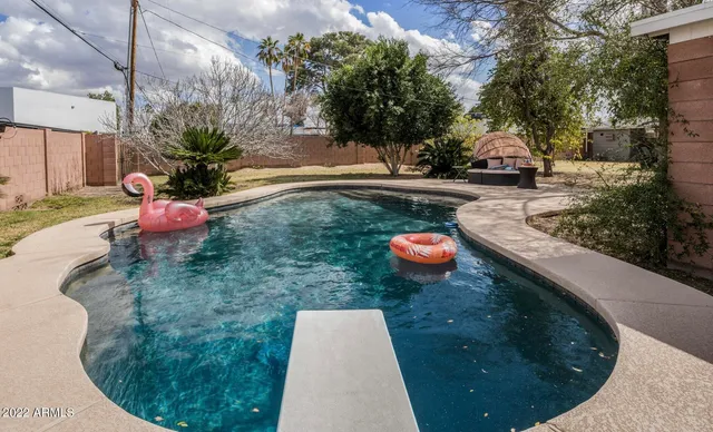 a backyard of a house with table and chairs