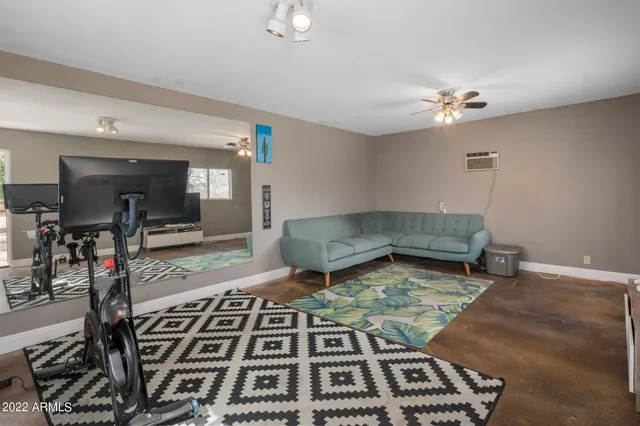 a living room with a rug and a dining table