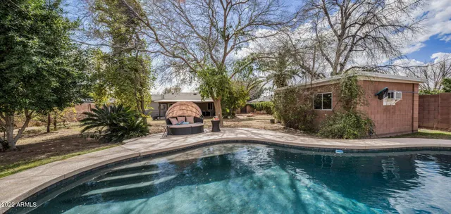 a swimming pool view with a outdoor seating