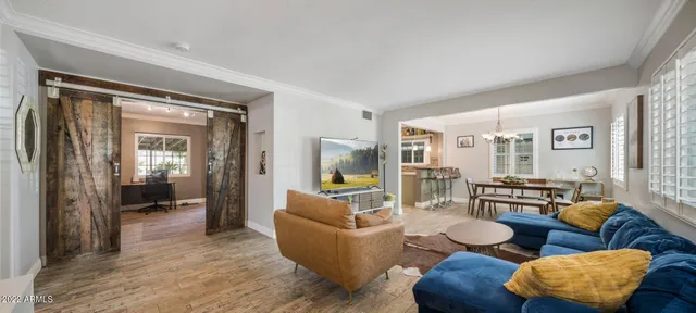 a living room with furniture and wooden floor