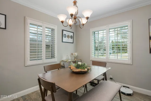 a view of a dining room with a table and chairs