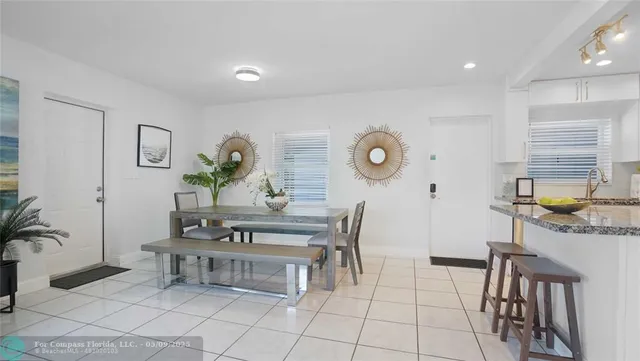 a kitchen with stainless steel appliances granite countertop a sink refrigerator and cabinets