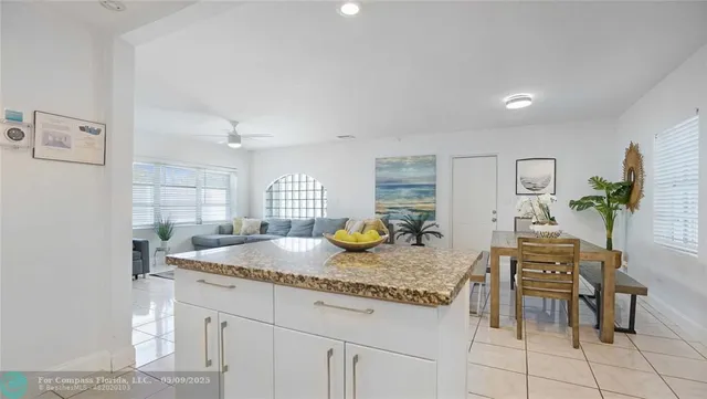 a kitchen with granite countertop a sink a stove and cabinets
