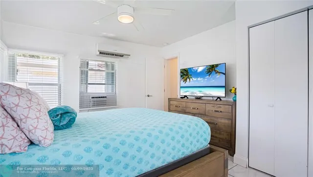 a view of a patio with couple of chairs and potted plants
