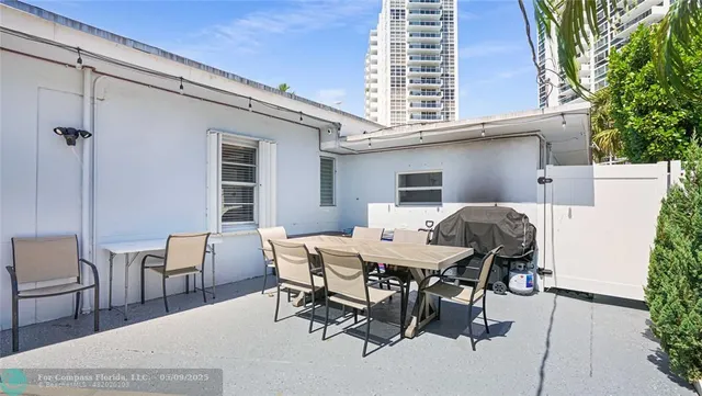 a view of a dinning table and chairs in patio
