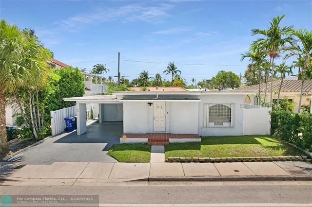 a kitchen with stainless steel appliances kitchen island granite countertop a refrigerator and a sink