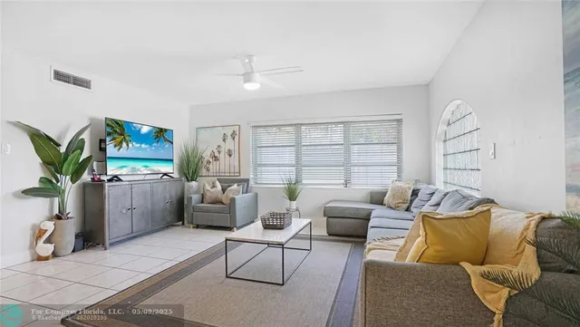 a living room with furniture and a large window