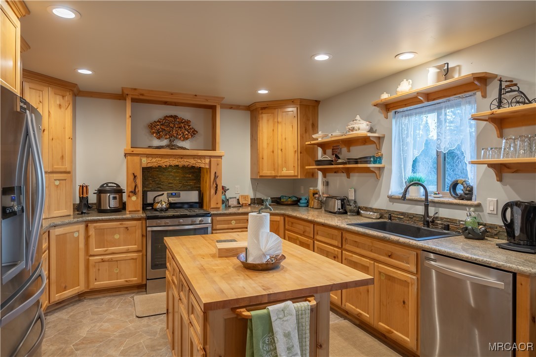 448 Edgemoor Road Big Bear Lake, CA 92315 - Photo 14 of 42 a kitchen with a sink stove and refrigerator