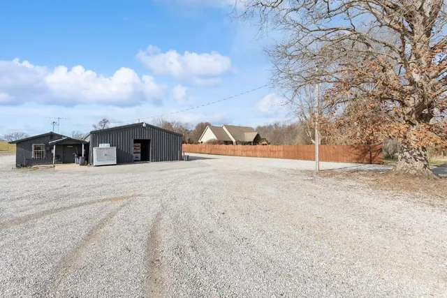 a view of empty house with wooden fence