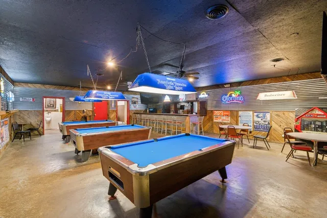 a room with furniture and pool table