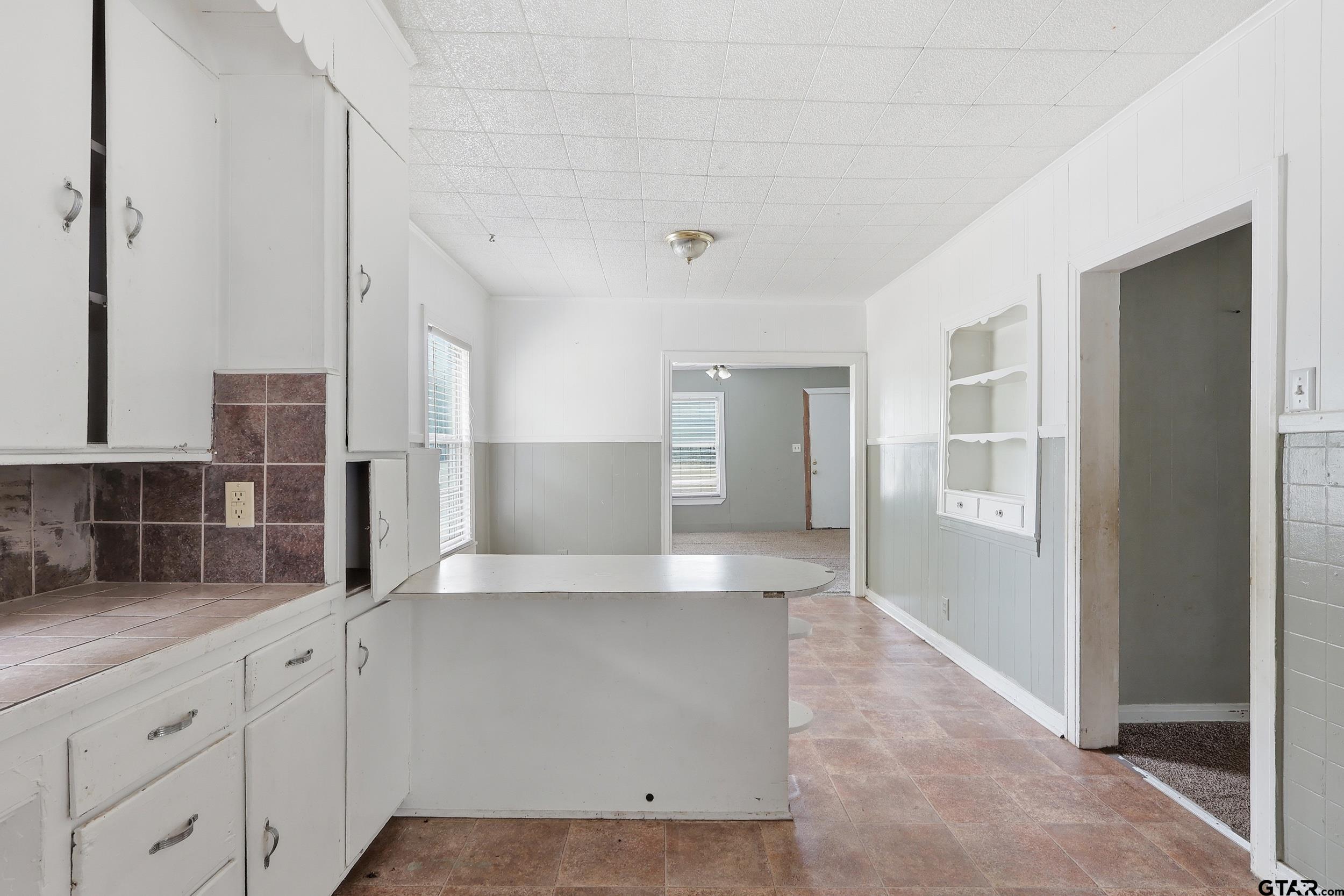 405 Rusk Street Pittsburg, TX 75686 - Photo 21 of 33 a large white kitchen with stainless steel appliances granite countertop a refrigerator and a sink