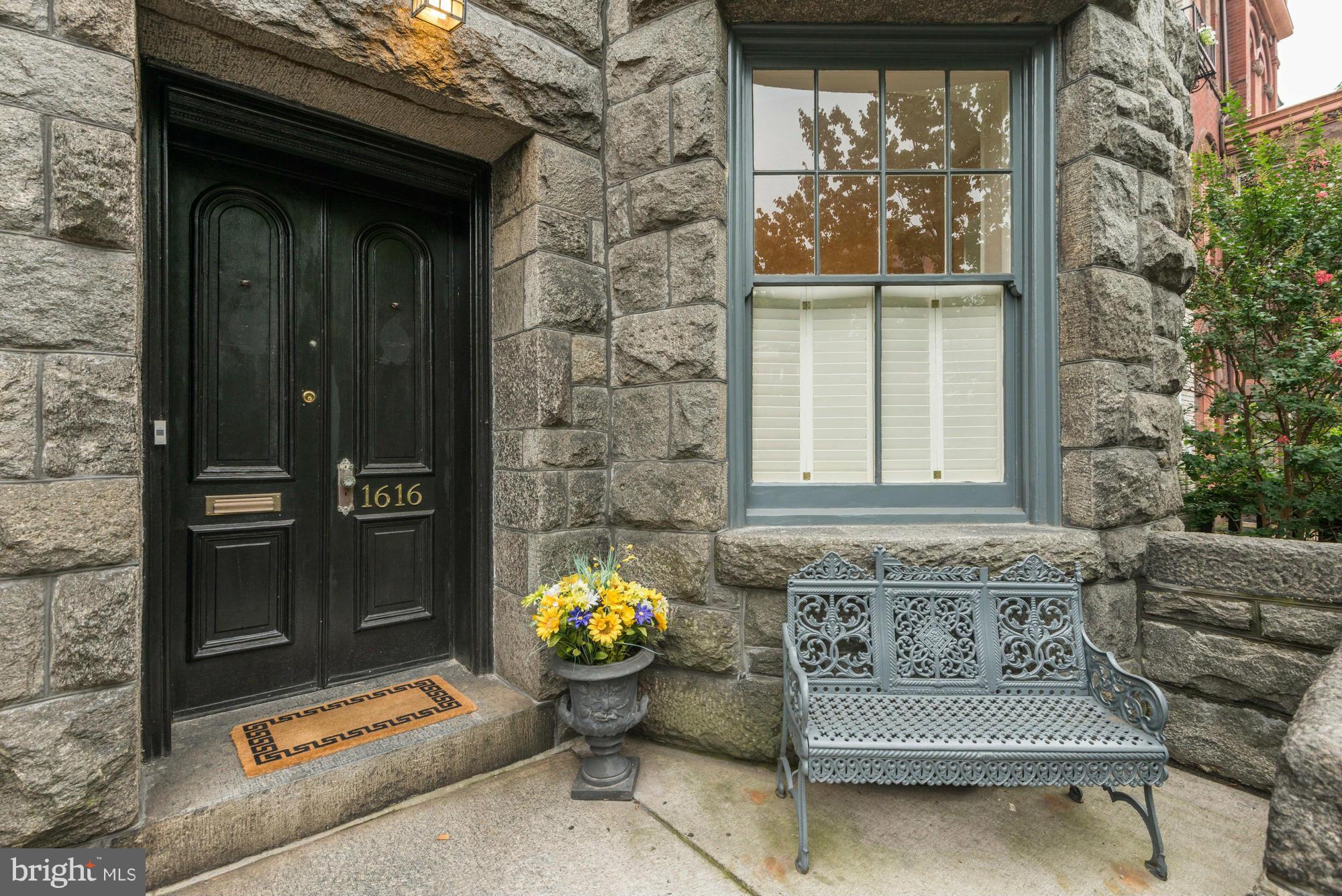 a front view of a house with outdoor seating